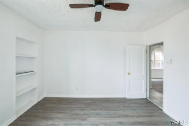 4931 Mardel Ave, Saint Louis, MO 63109 - spare room featuring built in features, a ceiling fan, wood finished floors, a textured ceiling, and baseboards