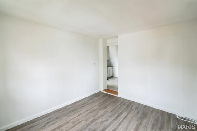 4931 Mardel Ave, Saint Louis, MO 63109 - spare room with wood finished floors and baseboards