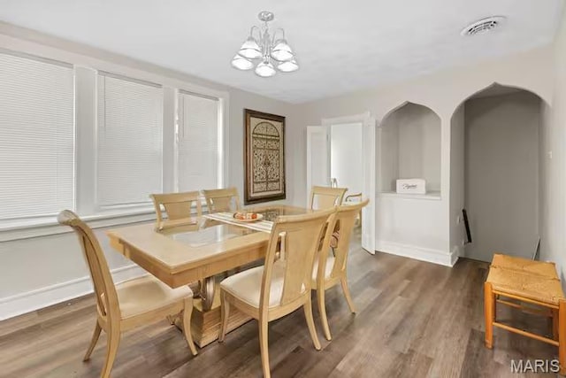 4931 Mardel Ave, Saint Louis, MO 63109 - dining room with wood finished floors, a chandelier, and baseboards
