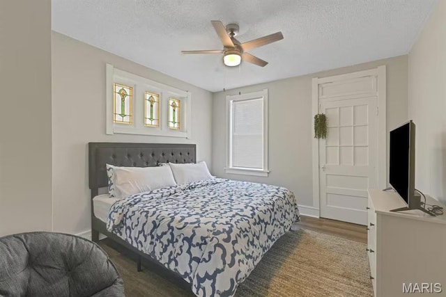 4931 Mardel Ave, Saint Louis, MO 63109 - bedroom with a textured ceiling, baseboards, wood finished floors, and ceiling fan