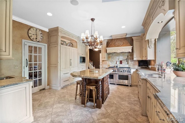 21 Log Cabin Dr, Saint Louis, MO 63124 - kitchen featuring range with two ovens, premium range hood, a sink, built in microwave, and a chandelier