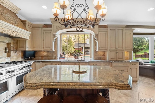 21 Log Cabin Dr, Saint Louis, MO 63124 - kitchen with range with two ovens, cream cabinetry, a sink, a chandelier, and crown molding