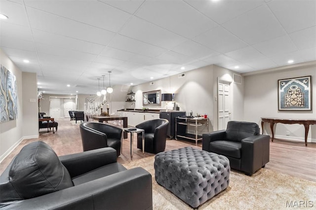 21 Log Cabin Dr, Saint Louis, MO 63124 - living area with baseboards, light wood-style floors, a paneled ceiling, and recessed lighting