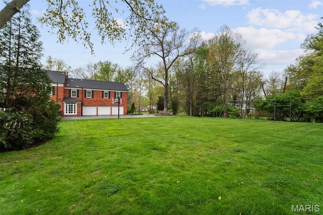 21 Log Cabin Dr, Saint Louis, MO 63124 - view of green lawn with a garage and driveway