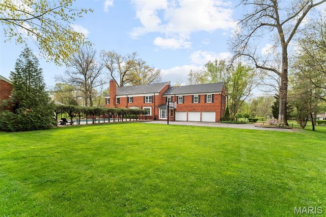 21 Log Cabin Dr, Saint Louis, MO 63124 - view of front of property with a garage, a chimney, brick siding, asphalt driveway, and a front lawn