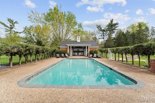 21 Log Cabin Dr, Saint Louis, MO 63124 - view of swimming pool featuring fence, a patio, an outdoor structure, and a storage structure
