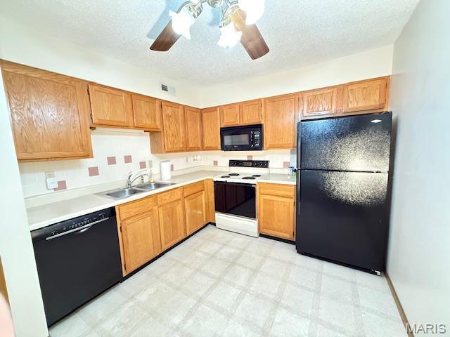 31 Berview Cir Unit H, Saint Louis, MO 63129 - kitchen with black appliances, a ceiling fan, a textured ceiling, light countertops, and light floors