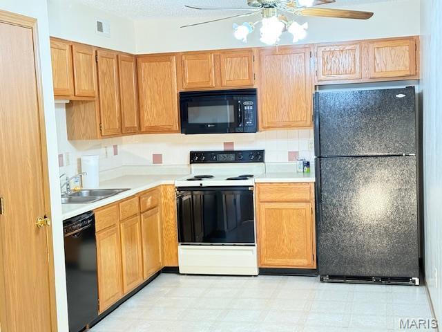 31 Berview Cir Unit H, Saint Louis, MO 63129 - kitchen featuring black appliances, ceiling fan, light countertops, and light flooring