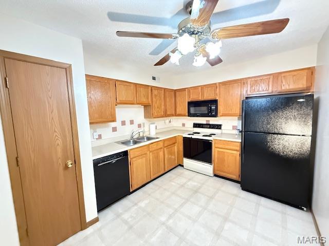 31 Berview Cir Unit H, Saint Louis, MO 63129 - kitchen with black appliances, light flooring, ceiling fan, and light countertops