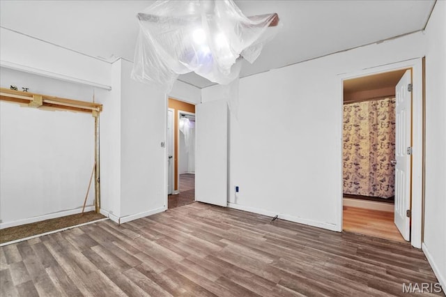 4321 E Fairfax Ct, Saint Louis, MO 63113 - unfurnished bedroom featuring wood finished floors and baseboards