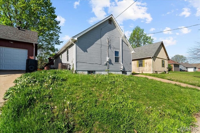 4321 E Fairfax Ct, Saint Louis, MO 63113 - view of side of home with a yard and concrete driveway