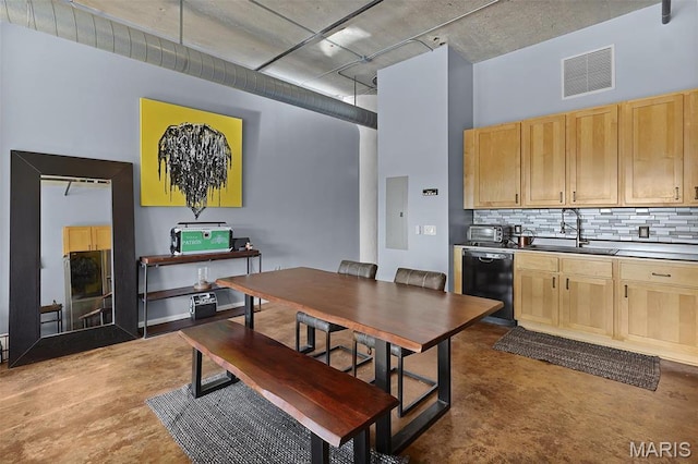 dining space with finished concrete flooring and electric panel