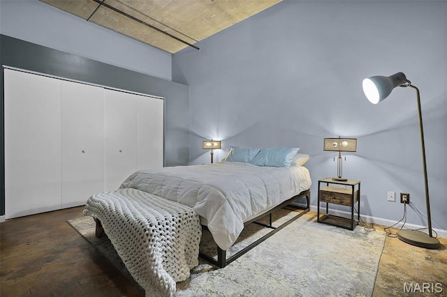 bedroom with a closet and concrete floors