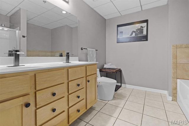full bath featuring a paneled ceiling, toilet, a shower with door, tile patterned floors, and baseboards
