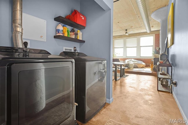 clothes washing area featuring washing machine and clothes dryer and baseboards