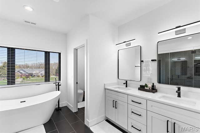 10010 Schuessler Rd, Saint Louis, MO 63128 - bathroom with double vanity, tile patterned floors, toilet, a soaking tub, and a shower stall