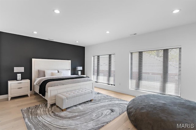 10010 Schuessler Rd, Saint Louis, MO 63128 - bedroom featuring recessed lighting, light wood-style flooring, an accent wall, and baseboards