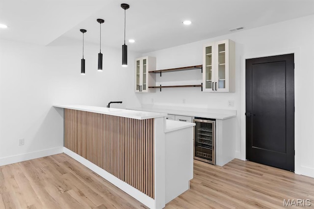 10010 Schuessler Rd, Saint Louis, MO 63128 - indoor wet bar featuring beverage cooler, light wood-style flooring, recessed lighting, pendant lighting, and baseboards