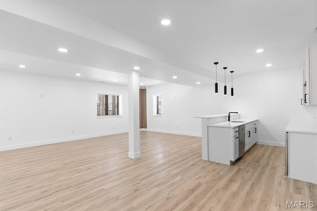 10010 Schuessler Rd, Saint Louis, MO 63128 - kitchen with open floor plan, recessed lighting, light wood-style flooring, hanging light fixtures, and light countertops