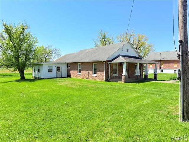5920 County Rd 20, Belleview, MO 63623 - back of house featuring covered porch, a lawn, brick siding, and a shingled roof