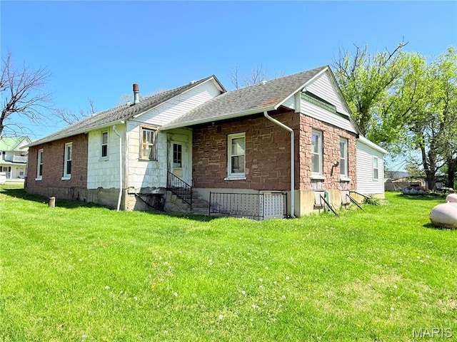5920 County Rd 20, Belleview, MO 63623 - view of front facade with entry steps, stone siding, a front yard, and a shingled roof