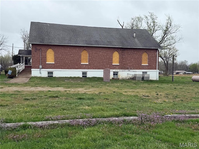 5920 County Rd 20, Belleview, MO 63623 - view of side of property with a yard, a shingled roof, and central AC