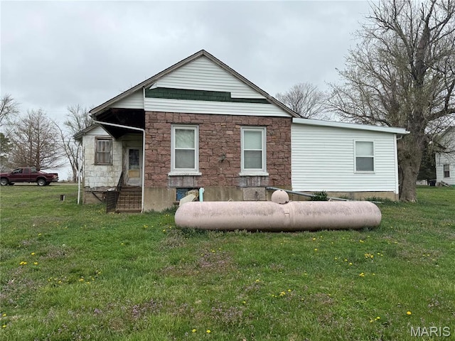 5920 County Rd 20, Belleview, MO 63623 - back of house with stone siding and a yard