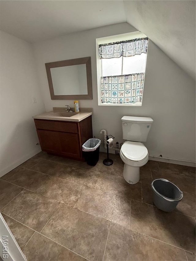 5920 County Rd 20, Belleview, MO 63623 - half bathroom with vaulted ceiling, toilet, vanity, and baseboards