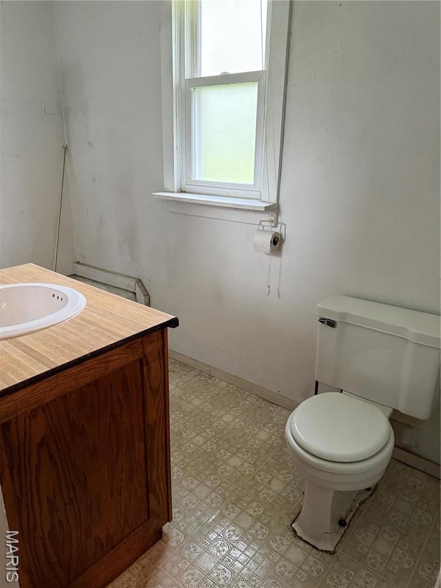 5920 County Rd 20, Belleview, MO 63623 - half bathroom with vanity, toilet, tile patterned floors, and baseboards