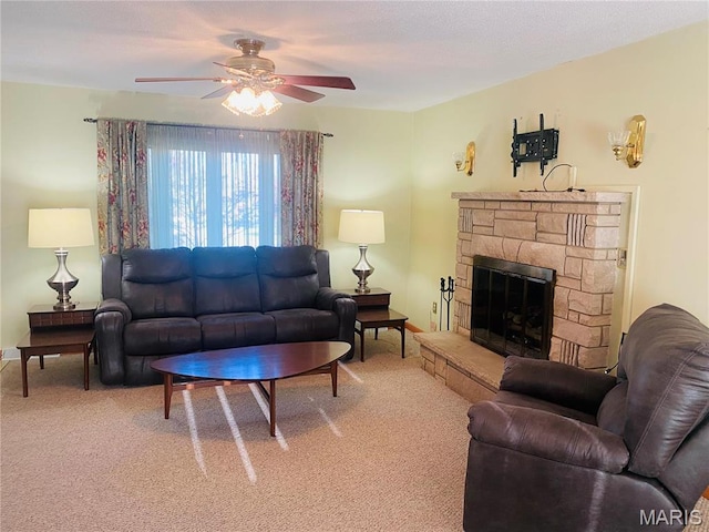 living area with a ceiling fan, light colored carpet, a fireplace, and baseboards