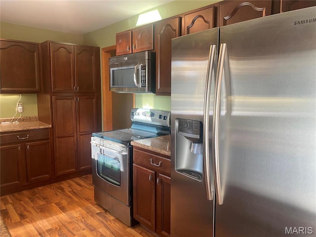 kitchen with stainless steel appliances and wood finished floors