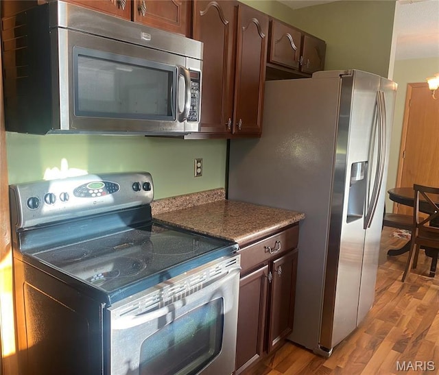 kitchen featuring stainless steel appliances and light wood-type flooring