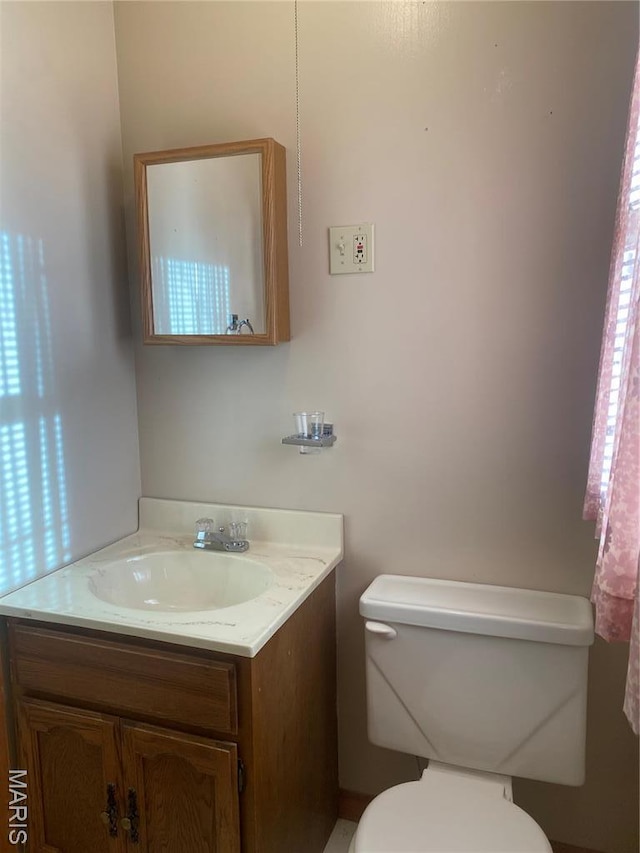 half bath with vanity and toilet
