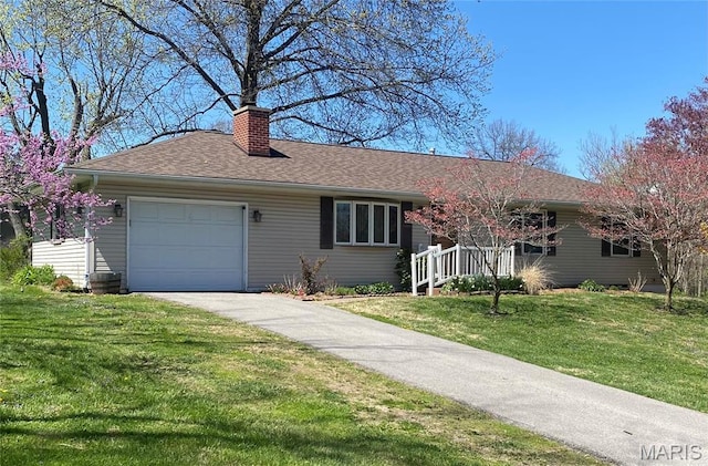 ranch-style home featuring a garage, a chimney, driveway, a front yard, and a shingled roof