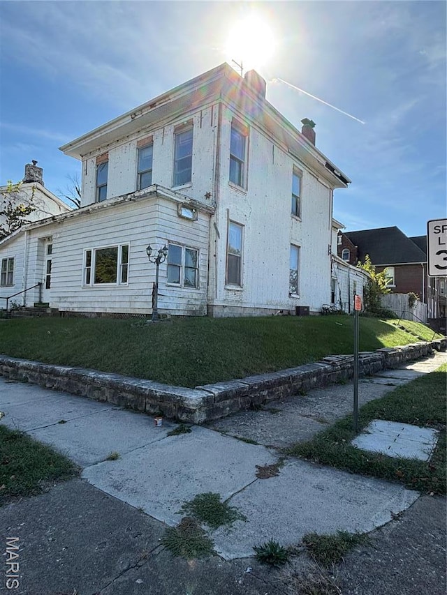 view of front of house featuring a chimney