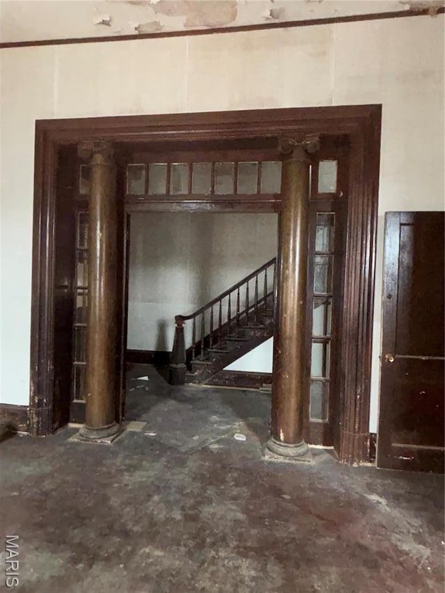 unfurnished living room featuring stairway