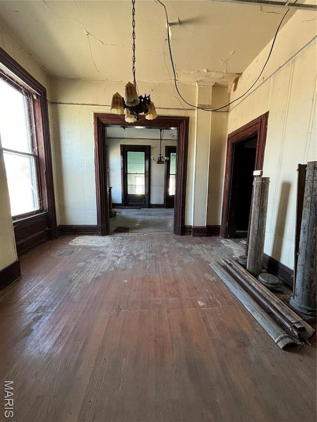 hallway with wood-type flooring and baseboards