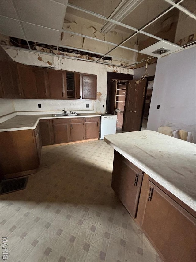 kitchen with light flooring, light countertops, and a sink