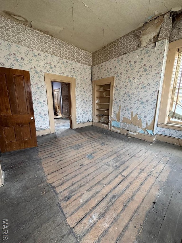 empty room featuring wallpapered walls