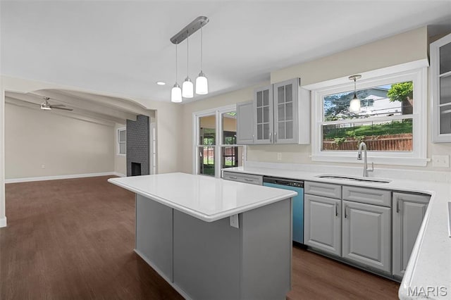 362 Hibler Ct, Saint Louis, MO 63141 - kitchen with stainless steel dishwasher, a sink, glass insert cabinets, open floor plan, and dark wood-type flooring