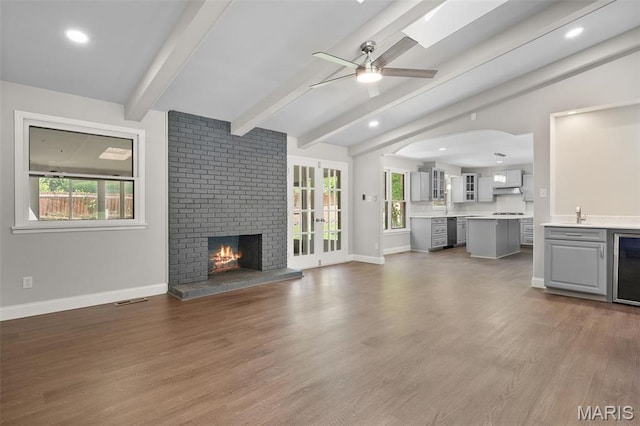 362 Hibler Ct, Saint Louis, MO 63141 - unfurnished living room featuring ceiling fan, healthy amount of natural light, a fireplace, baseboards, and recessed lighting