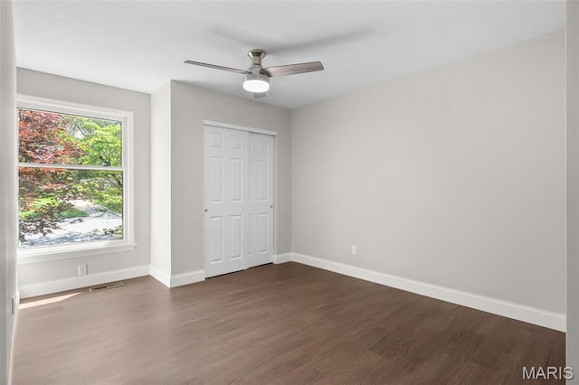 362 Hibler Ct, Saint Louis, MO 63141 - unfurnished bedroom featuring dark wood-style flooring, baseboards, ceiling fan, and a closet