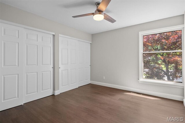 362 Hibler Ct, Saint Louis, MO 63141 - unfurnished bedroom featuring dark wood-style flooring, multiple windows, baseboards, and ceiling fan