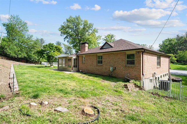 362 Hibler Ct, Saint Louis, MO 63141 - rear view of house with a sunroom, brick siding, a chimney, and roof with shingles