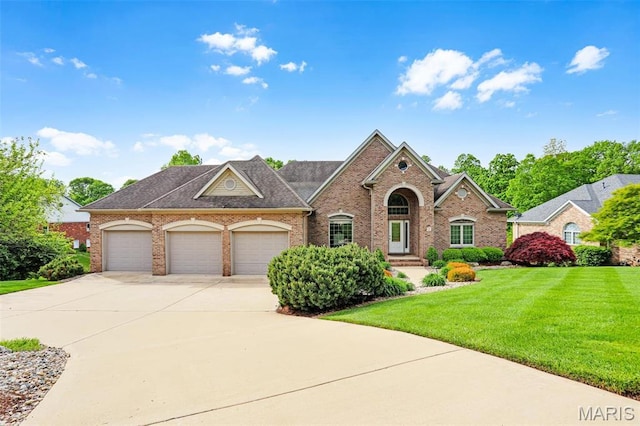 traditional-style home with brick siding, driveway, and a front yard