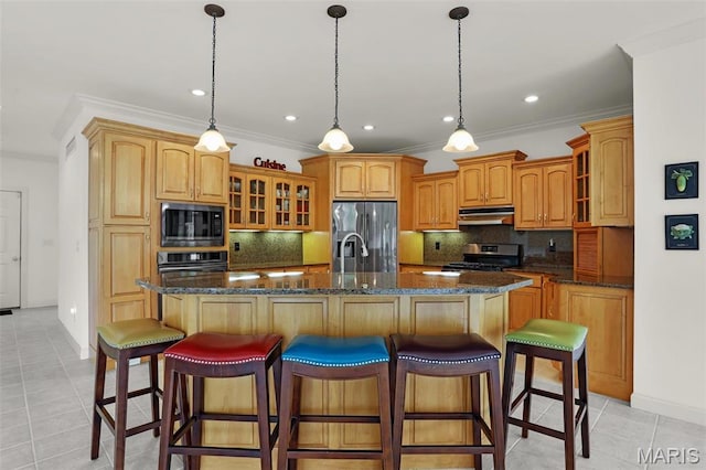 kitchen featuring stainless steel appliances, under cabinet range hood, ornamental molding, glass insert cabinets, and light tile patterned floors