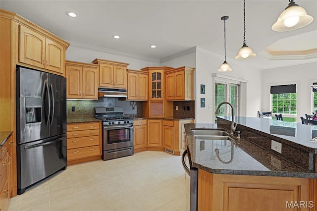 kitchen with black fridge, stainless steel gas stove, under cabinet range hood, a sink, and crown molding