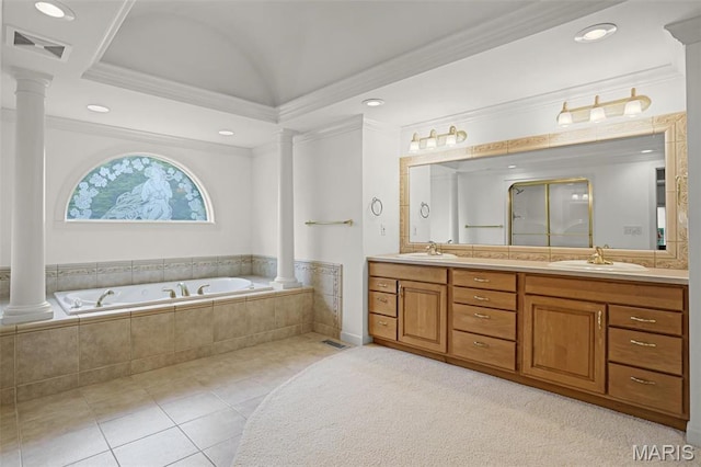 full bath featuring ornate columns, ornamental molding, a garden tub, double vanity, and tile patterned flooring