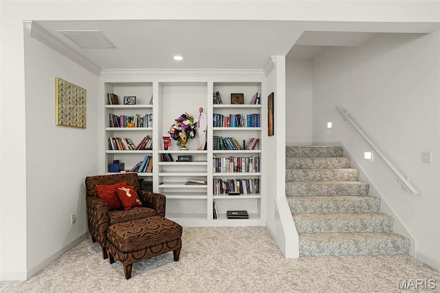 living area with carpet floors, stairway, baseboards, and crown molding