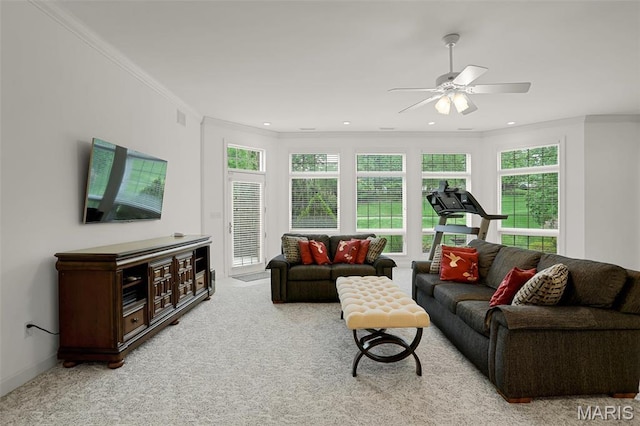 carpeted living room featuring ceiling fan and ornamental molding